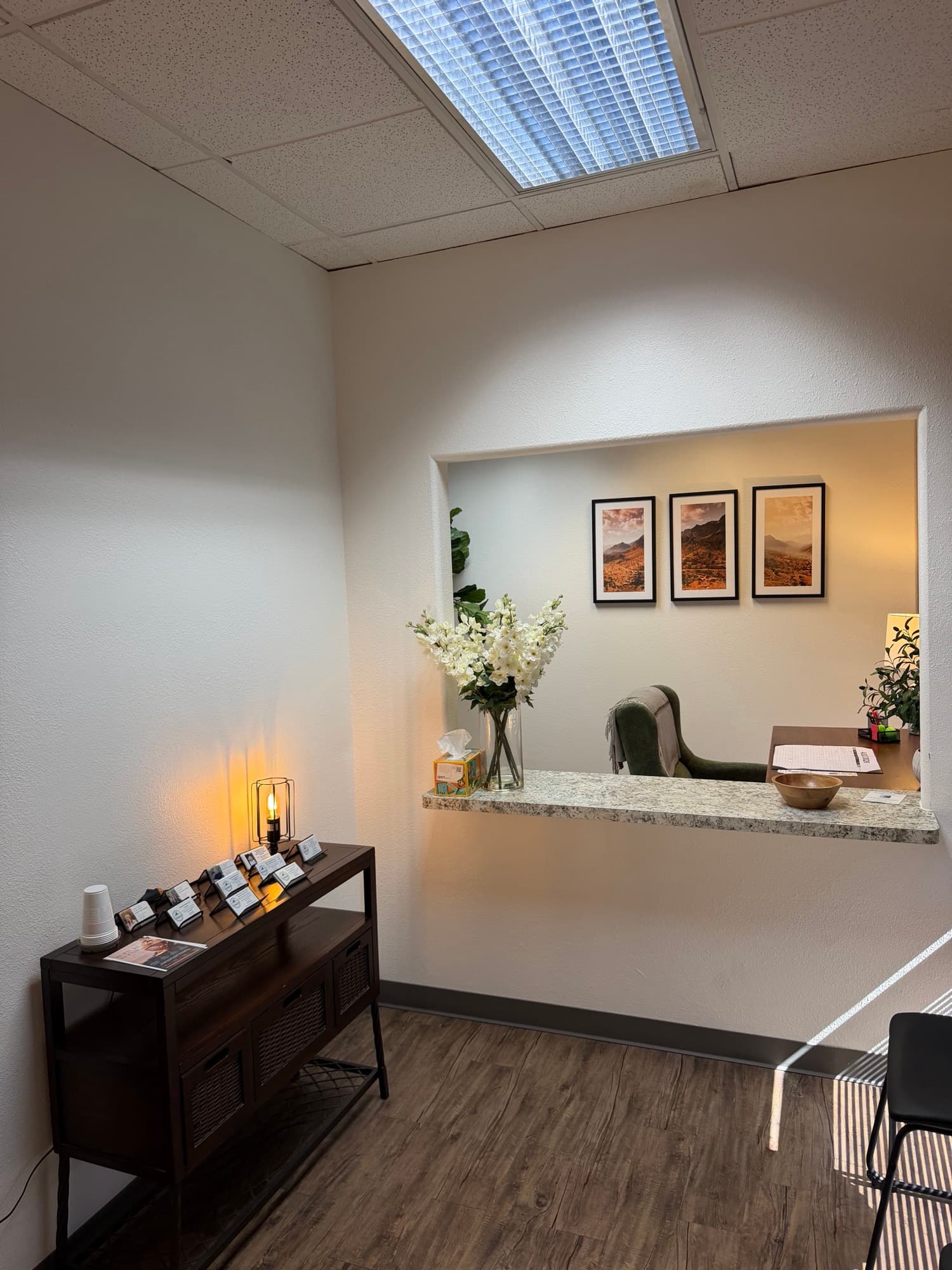 Front desk nook with fresh flowers and framed desert photography