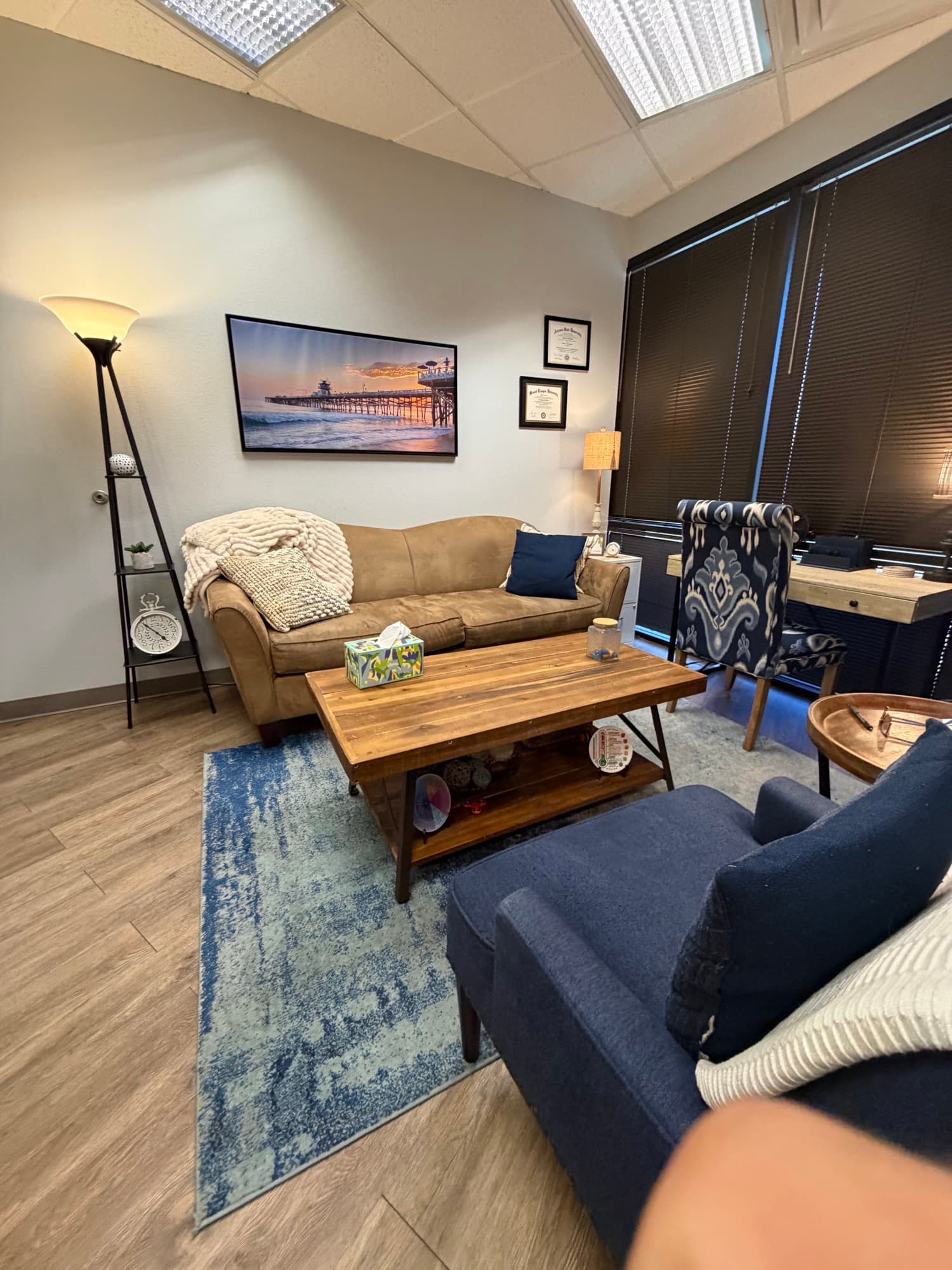 Therapy room with a pier photograph and blue accent chair