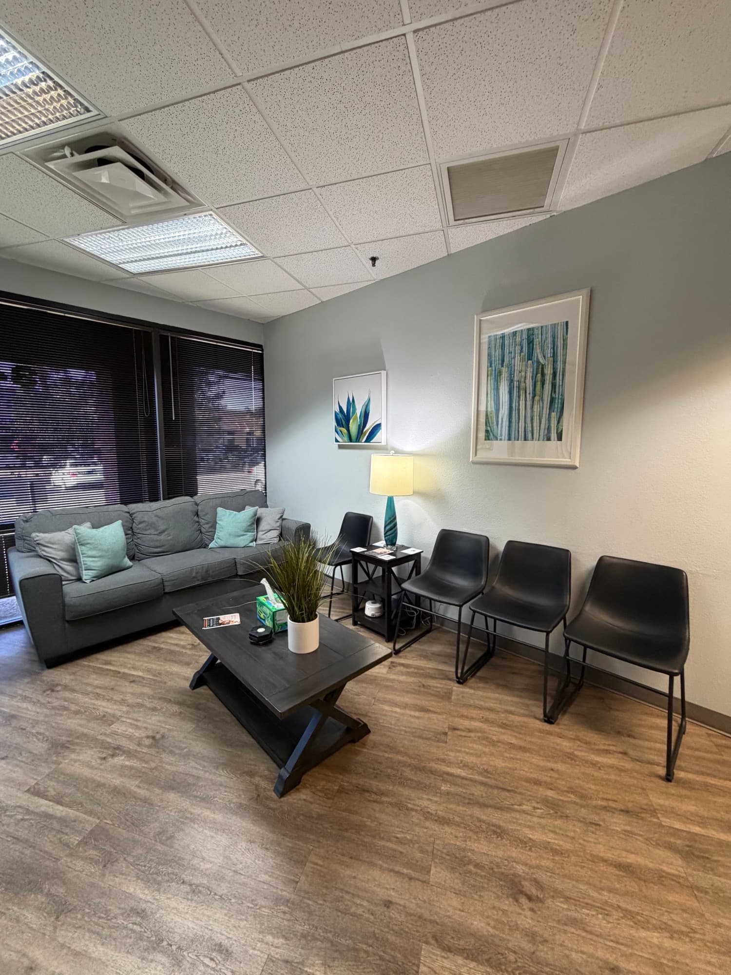 Waiting area with comfortable seating and botanical art