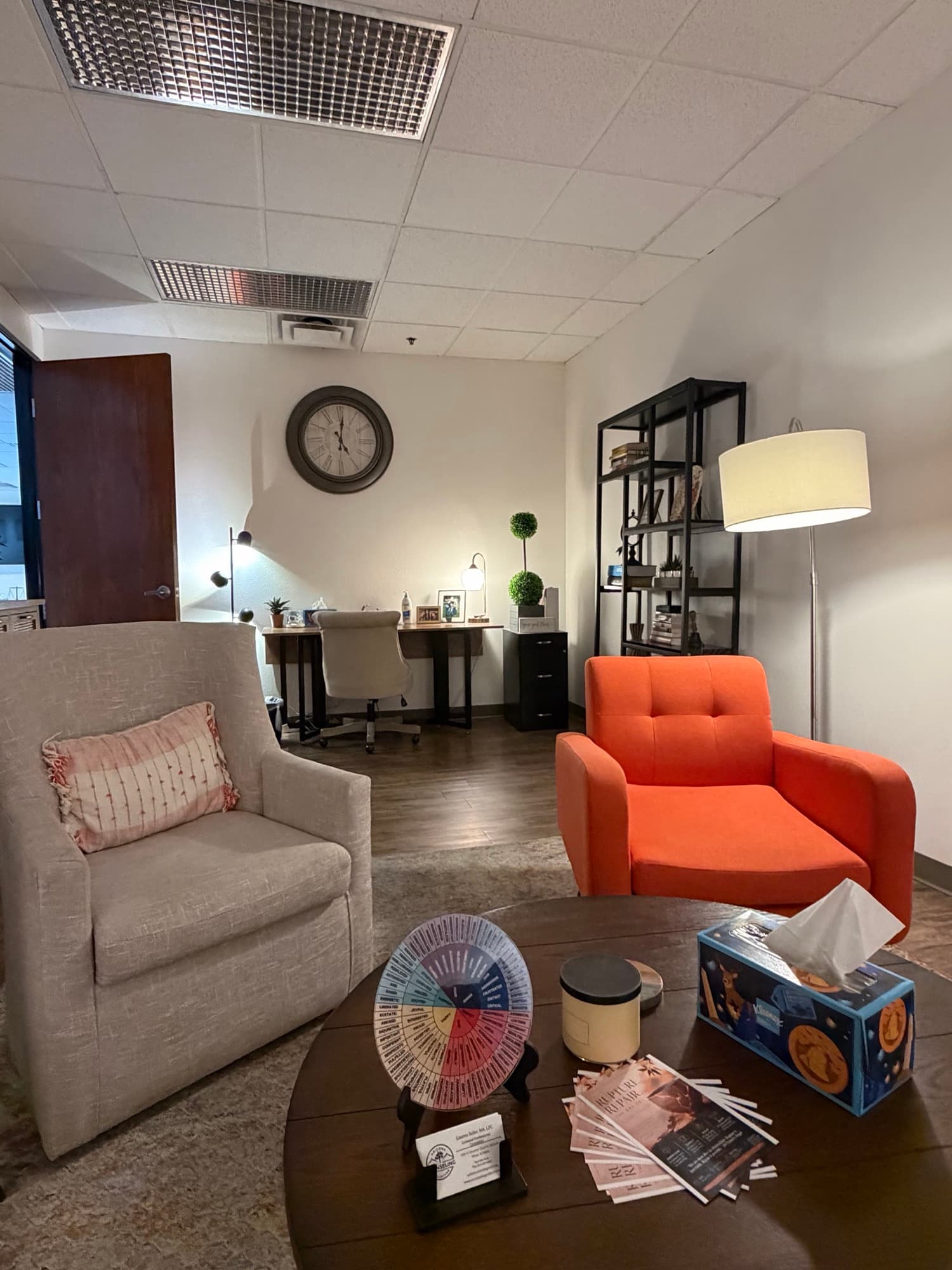 Therapy room with an emotions wheel and cozy seating